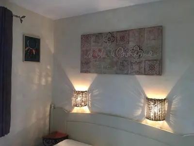 a bedroom with two lights on the wall at Bastidon la Cicada in Gordes