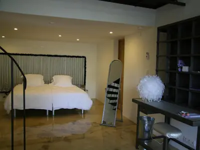 a bedroom with a bed and a mirror and a shelf at Couleur Lavande in Le Thor