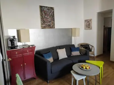 a living room with a couch and a table at Gîte en Provence in Entraigues-sur-la-Sorgue