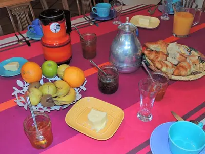 a table with a pink table cloth with fruit on it at Les Chênes Verts in La Bastidonne
