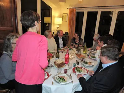 a group of people sitting around a table eating at Les Chênes Verts in La Bastidonne