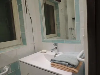 a bathroom with a sink and a mirror at Les Chênes Verts in La Bastidonne