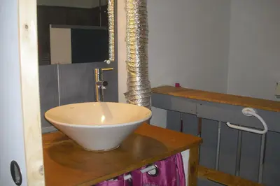 a bathroom with a bowl sink on a counter at Lou mas li Pitchoun 