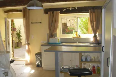 a kitchen with a sink and a window at Lou mas li Pitchoun 