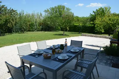 a blue table with chairs and a bottle of wine at Campagne Chastel in Aix-en-Provence