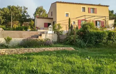 a house in front of a yard with green grass at 2 Bedroom Stunning Home In Apt in Apt