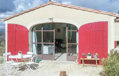 a red and white house with a table and chairs at 2 Bedroom Stunning Home In Apt in Apt