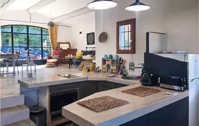 a kitchen with a counter top with a refrigerator at 2 Bedroom Stunning Home In Apt in Apt