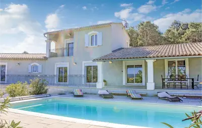 a villa with a swimming pool in front of a house at 4 Bedroom Awesome Home In Apt in Apt