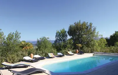a swimming pool with lounge chairs and a swimming pool at 4 Bedroom Awesome Home In Apt in Apt