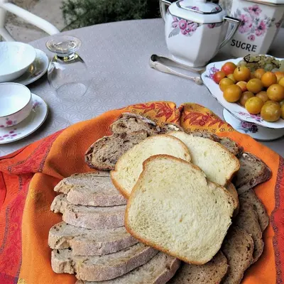 a plate of bread and toast on a table at La Buissonnière in Oppède