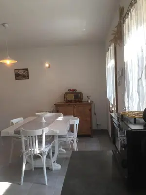 a white dining room with a white table and chairs at Maison de vacances Jocelyne in Lauris