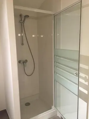a shower with a glass shower stall in a bathroom at Maison de vacances Jocelyne in Lauris
