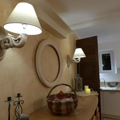 a bathroom with a mirror and a basket on a counter at Maison d'hôtes Une hirondelle en Provence in Roussillon