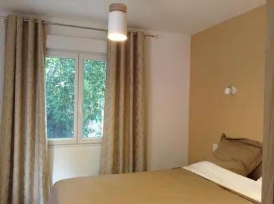 a bedroom with a bed and a window at Villa hortensia in Carpentras