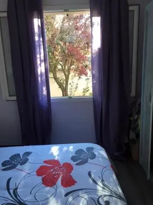 a bed in a room with a window at Villa hortensia in Carpentras