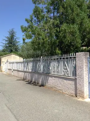 a metal fence on the side of a road at Villa hortensia in Carpentras