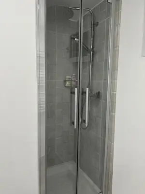 a shower with a glass door in a bathroom at Villa hortensia in Carpentras