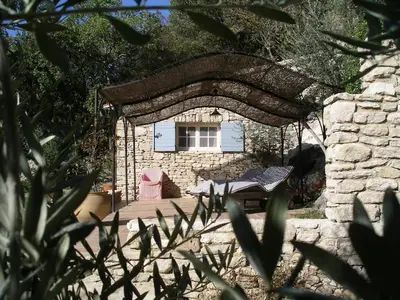 a swimming pool with blue water in a yard at La Baumo 1 und 2 in Le Beaucet