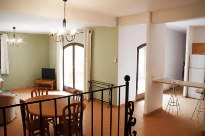 a kitchen and dining room with a table and chairs at Le Relais Du Grand Logis in Mirabeau