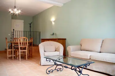a living room with a couch and a table at Le Relais Du Grand Logis in Mirabeau