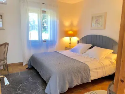 a bedroom with a bed and a window at B&B La Badelle in Gordes