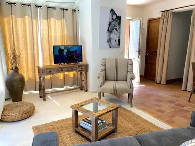 a living room with a couch and a chair and a tv at B&B La Badelle in Gordes