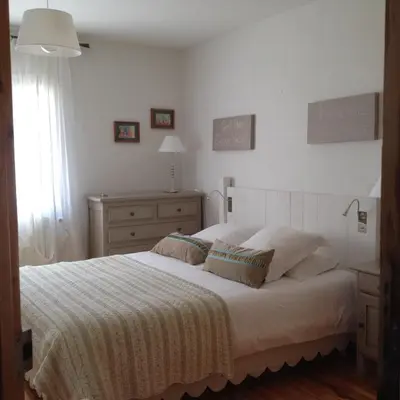 a bedroom with a large white bed with two pillows at B&B La Badelle in Gordes