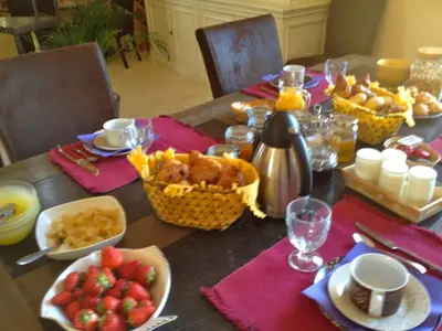 a table topped with a table with food and fruit at B&B La Badelle in Gordes