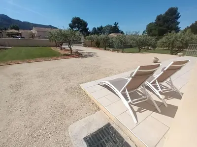 a group of chairs sitting on a patio at Le Jardin des Tourterelles in Robion en Luberon