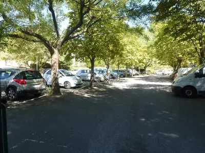 a row of cars parked in a parking lot with trees at Apartment Les Muriers Blancs in Aix-en-Provence