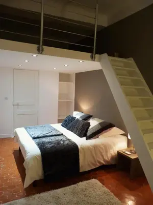a bedroom with a bunk bed with a ladder at Appartement coeur historique Aix in Aix-en-Provence