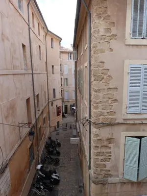 an alley with motorcycles parked between two buildings at Appartement coeur historique Aix in Aix-en-Provence