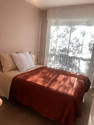 a bedroom with a bed with a large window at Logement promenade de la torse à Aix-en-Provence in Aix-en-Provence