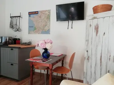a room with a table with a vase of flowers on it at Domaine Saint Jean in Saint-Saturnin-les-Apt