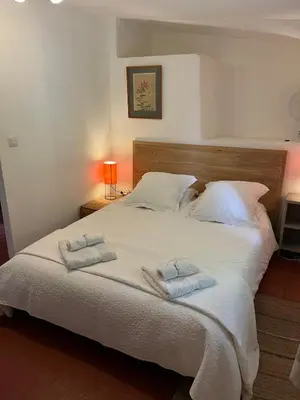 a bedroom with a large bed with two towels on it at Domaine Saint Jean in Saint-Saturnin-les-Apt