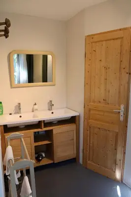 a bathroom with a sink and a mirror and a door at Domaine Saint Jean in Saint-Saturnin-les-Apt