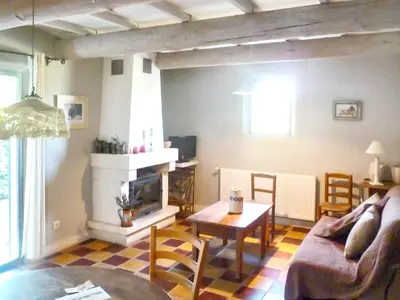 a living room with a couch and a table at Maison charmante à Oppède avec vue sur la montagne in Oppède