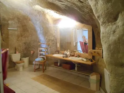 a bathroom with a sink and a mirror in a cave at Luberon maison de village entière 2 à 6 personnes in Cabrières-dʼAigues