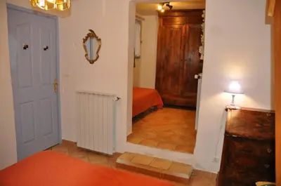 a hallway with a room with a bed and a door at Le Petit Labouret in Revest-du-Bion