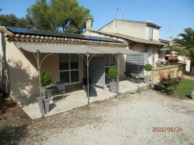 a house with a white awning on a patio at Mas les vieux chênes in Lambesc