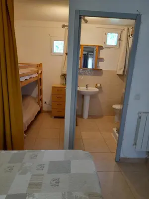 a bathroom with a bed and a sink and a toilet at Gîte chez Cécile à Lagnes, aux portes du Luberon in Lagnes