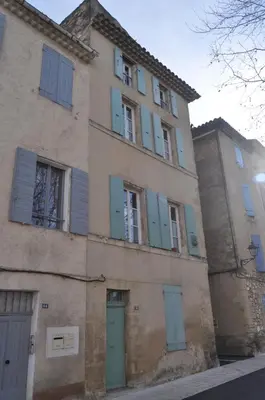 an old building with blue shutters on it at Appartement le Platane in Pertuis