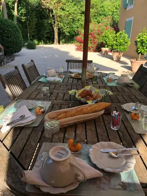 a wooden table with a teapot and food on it at Le Mas de Trévouse in Saint-Saturnin-lès-Avignon