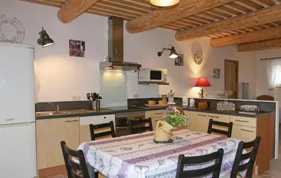 a kitchen with a table with a table cloth at Cozy Home In Pernes Les Fontaines in Pernes-les-Fontaines
