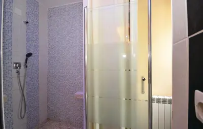 a shower with a glass door in a bathroom at Beautiful Home In Maubec in Maubec