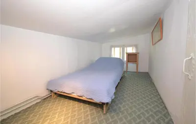 a small bedroom with a bed in a white room at Cozy Home In Crillon Le Brave With Wifi in Crillon-le-Brave