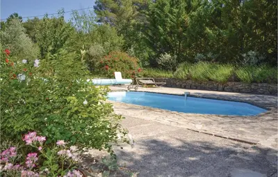 a pool in a yard with a bench and flowers at Cozy Home In Crillon Le Brave With Wifi in Crillon-le-Brave