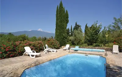 a swimming pool with lounge chairs and a swimming pool at Awesome Home In Crillon Le Brave in Crillon-le-Brave
