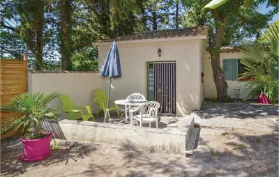 a patio with an umbrella and a table and chairs at Amazing Home In Crillon Le Brave in Crillon-le-Brave